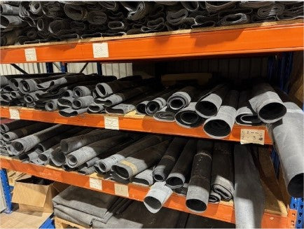 Rolled EPDM offcuts stacked on warehouse racking