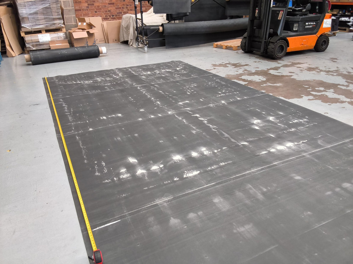 A seconds EPDM sheet laid out with a tape measure